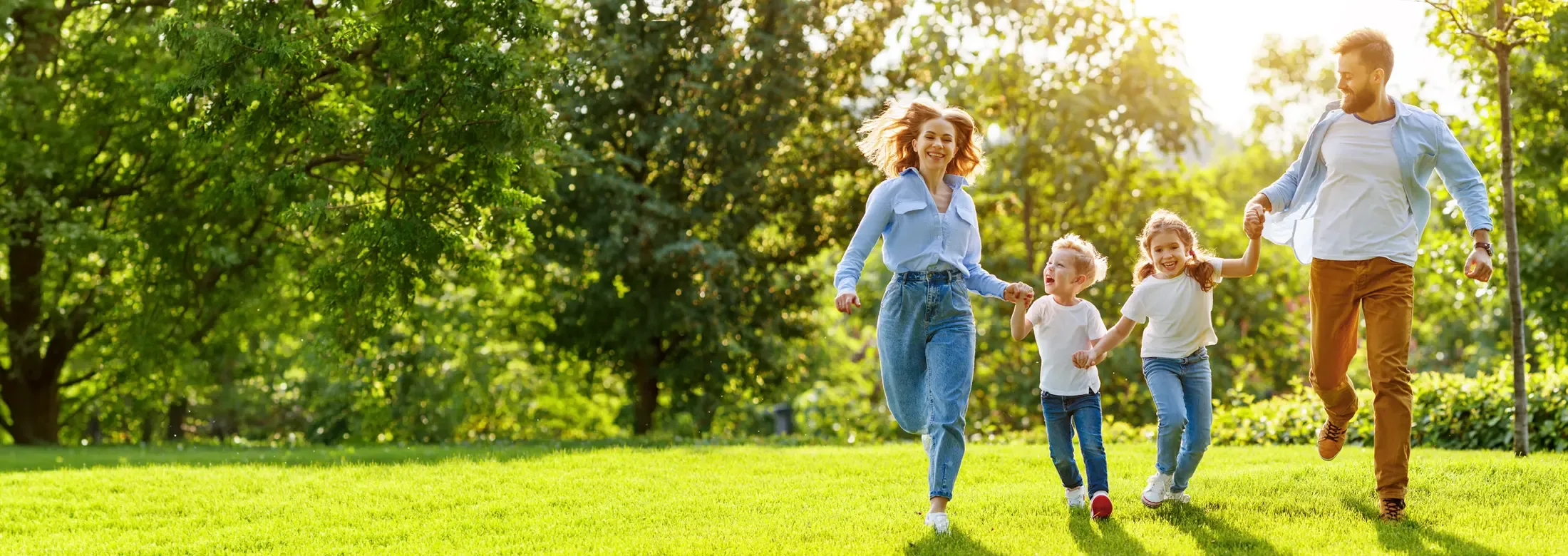 family running outside in their yard
